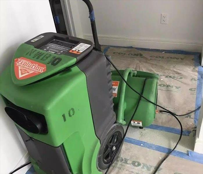 SERVPRO equipment on the floor of a room. 