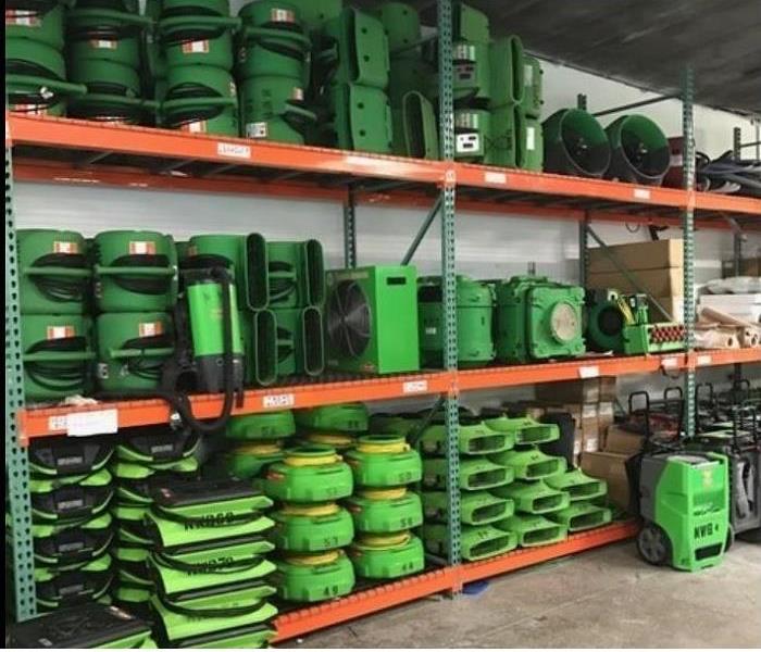 SERVPRO restoration equipment stacked on shelves in warehouse